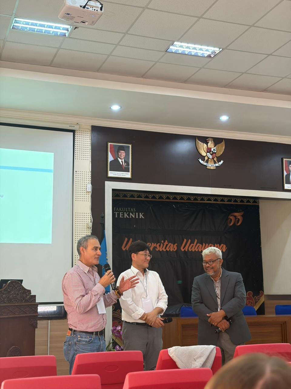 Prof. Khanal speaking alongside fellow presenters at Universitas Udayana